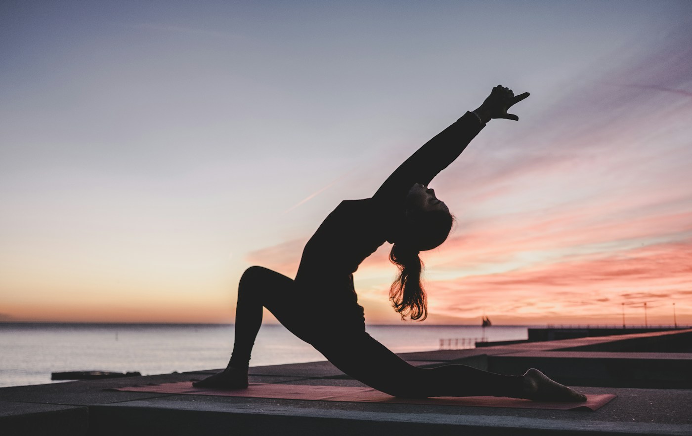 Yoga by the water at sunset